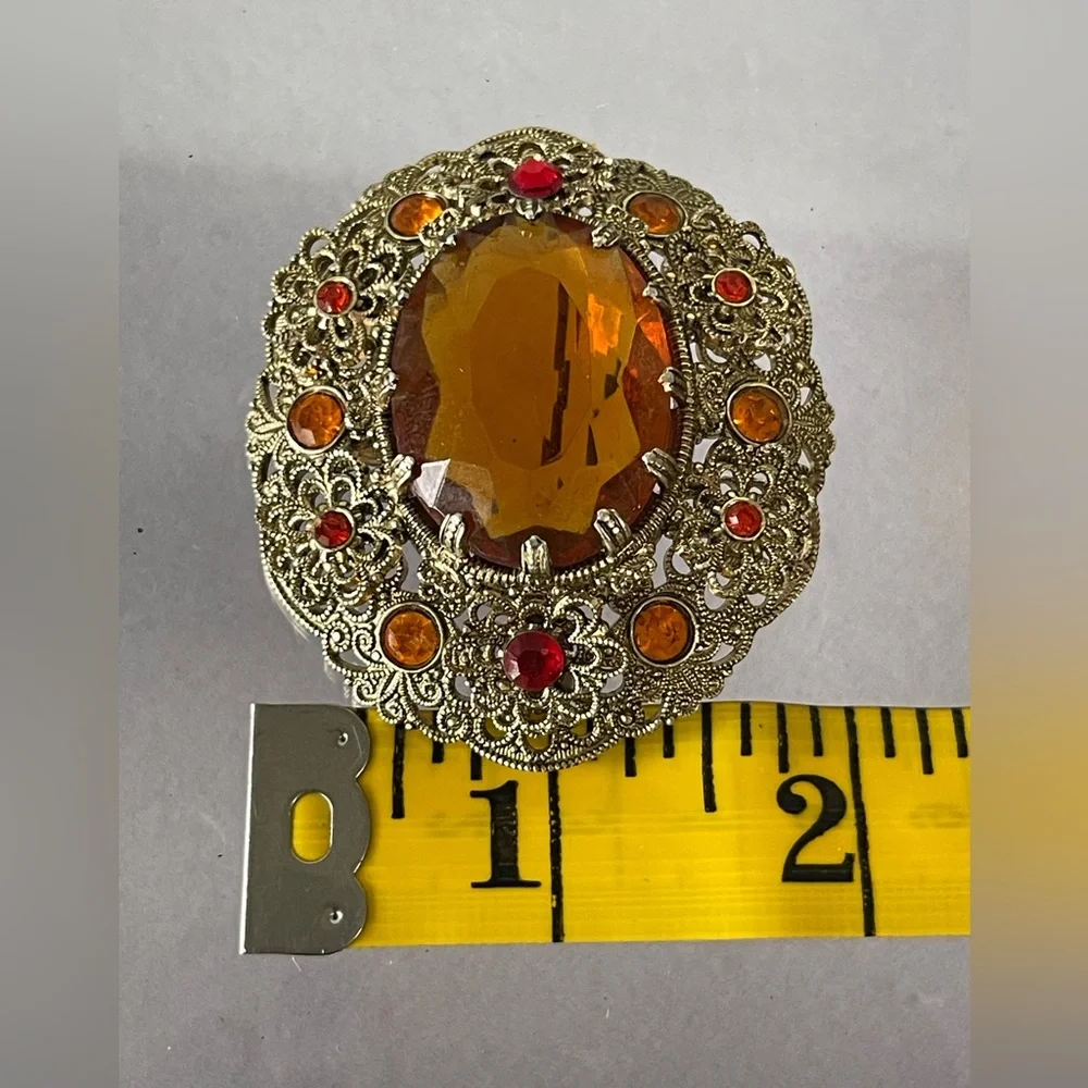 Vintage West Germany brooch featuring a large amber topaz glass filigree gold